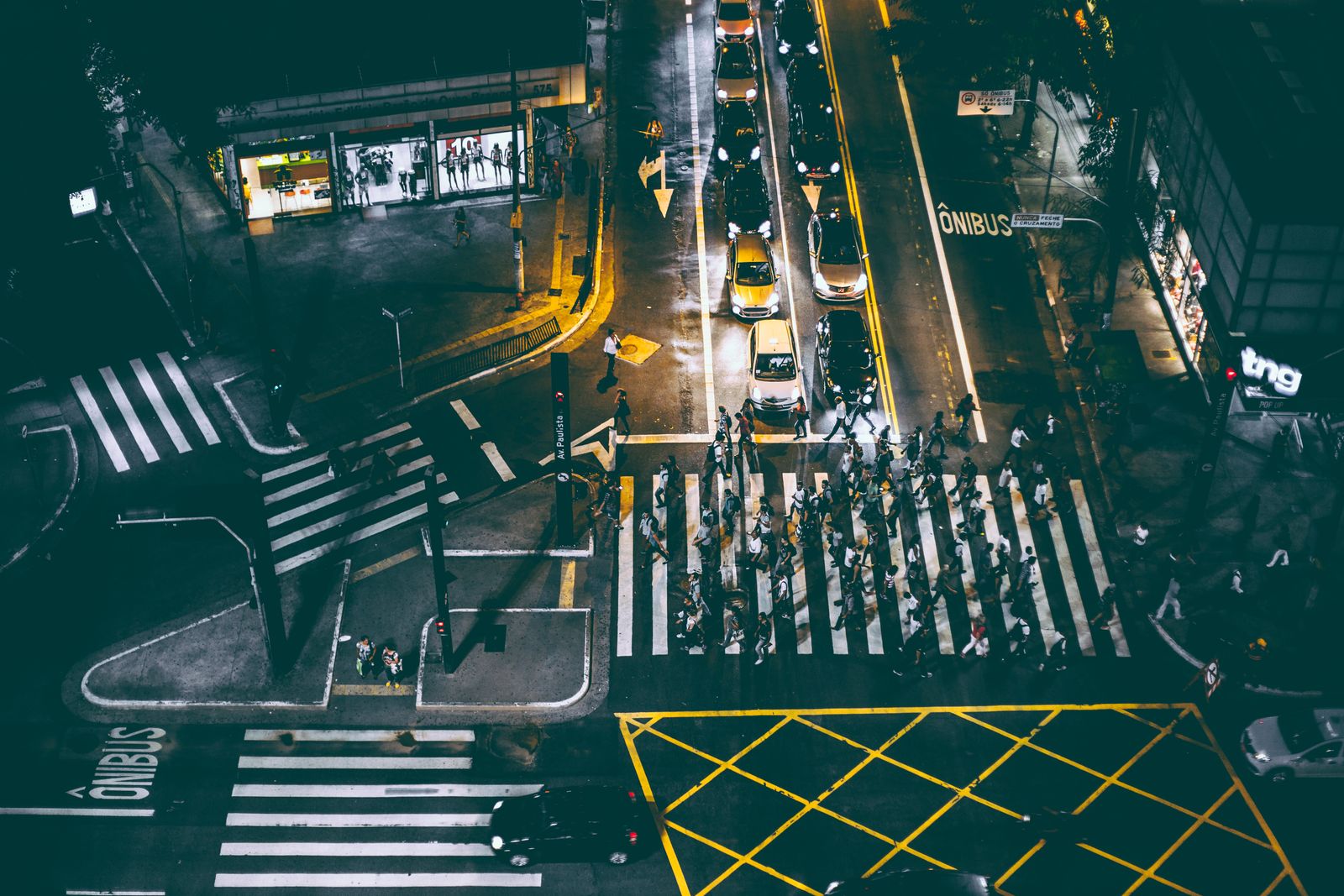 Aerial view of pedestrians crossing a city street at night